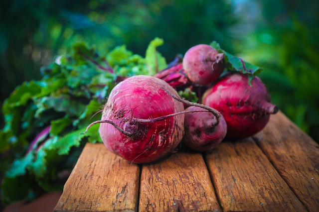 Bunch of gorgeous looking red beets on a table.